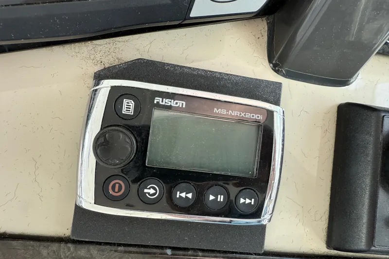 Turn The Page Yacht Photos Pics Fusion MS-NRX200i marine stereo remote on 2006 Sea Ray 48 Sundancer dashboard.