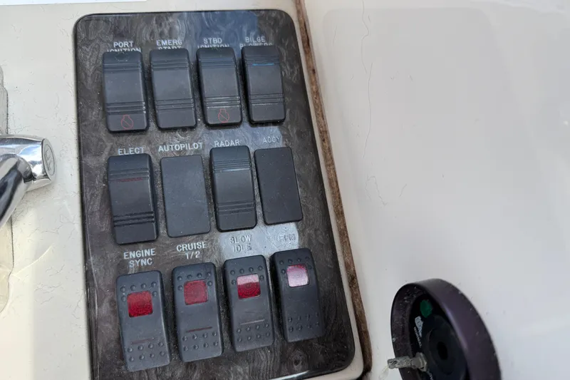 Turn The Page Yacht Photos Pics Control panel of a 2006 Sea Ray 48 Sundancer boat with various switches.