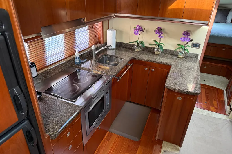 Turn The Page Yacht Photos Pics Luxurious kitchen interior of 2006 Sea Ray 48 Sundancer yacht with modern amenities.
