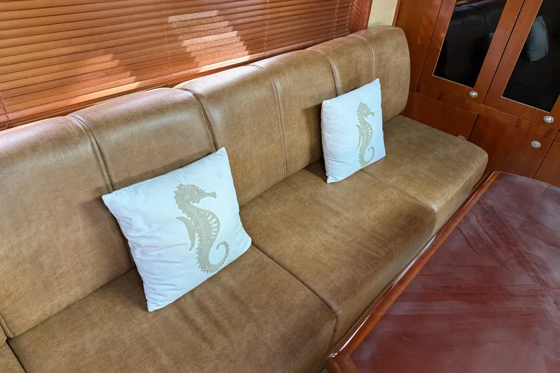 Turn The Page Yacht Photos Pics Luxurious interior of 2006 Sea Ray 48 Sundancer with seahorse-themed cushions.