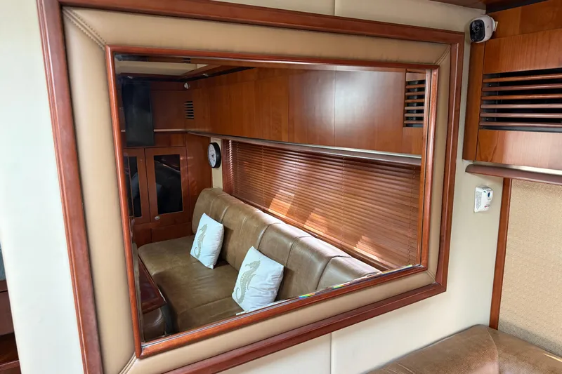 Turn The Page Yacht Photos Pics Luxurious interior of 2006 Sea Ray 48 Sundancer yacht with leather seating and wooden accents.
