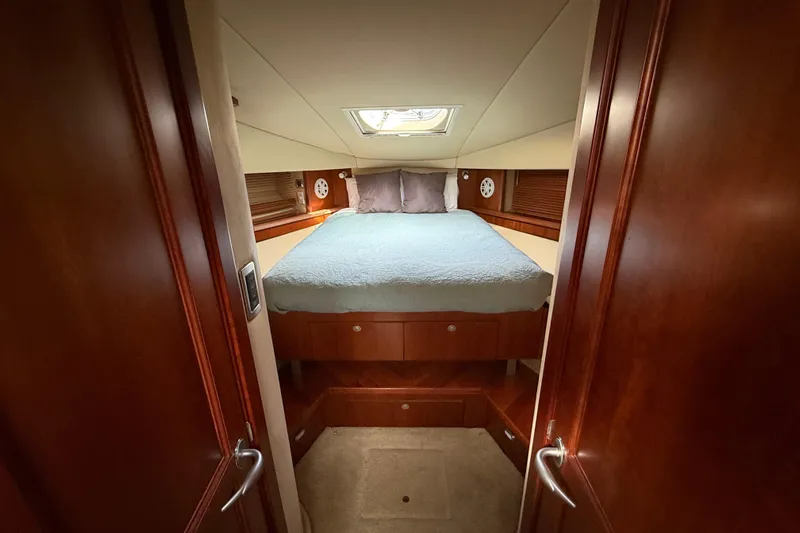 Turn The Page Yacht Photos Pics Luxurious cabin interior of 2006 Sea Ray 48 Sundancer yacht with cozy bed.