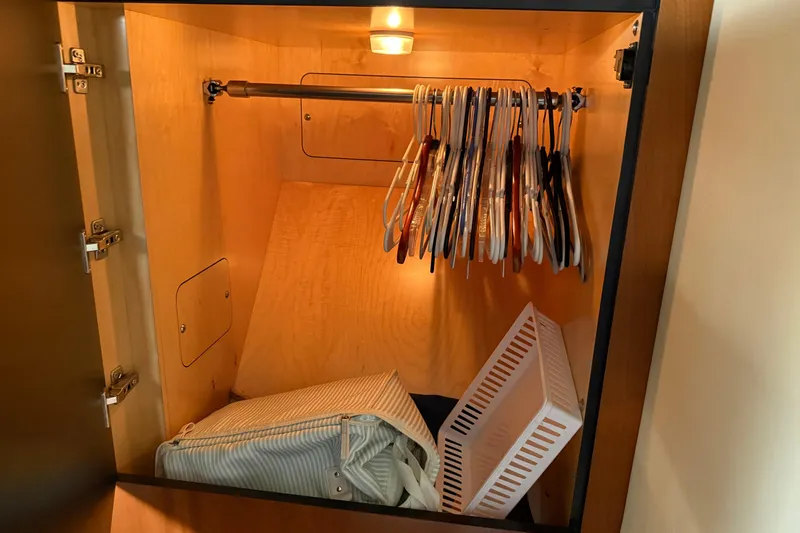 Turn The Page Yacht Photos Pics Wooden closet with hangers and storage in 2006 Sea Ray 48 Sundancer yacht.