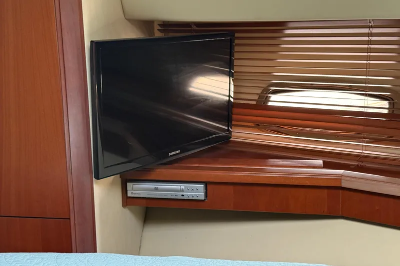 Turn The Page Yacht Photos Pics Interior of 2006 Sea Ray 48 Sundancer with TV and DVD player setup.