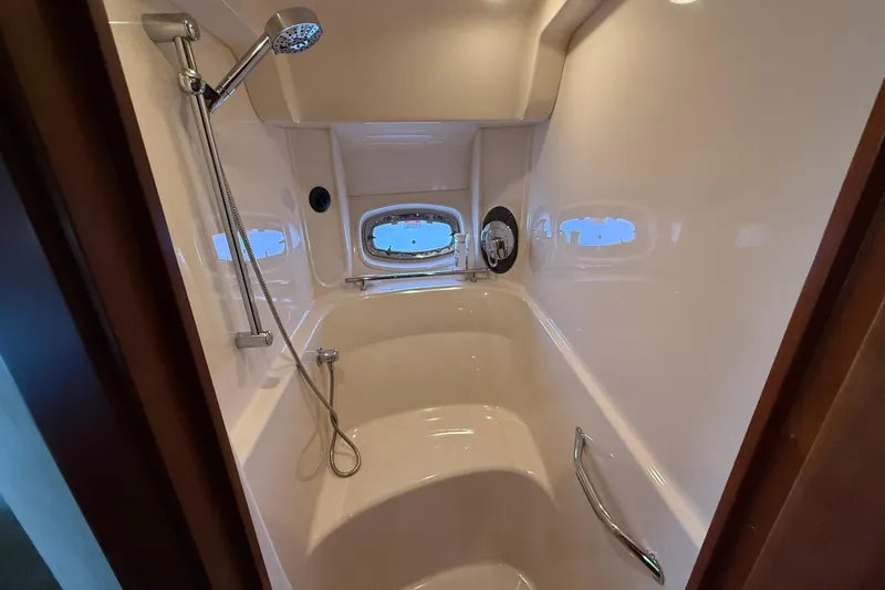 Turn The Page Yacht Photos Pics Luxurious shower area in 2006 Sea Ray 48 Sundancer yacht with modern fixtures.