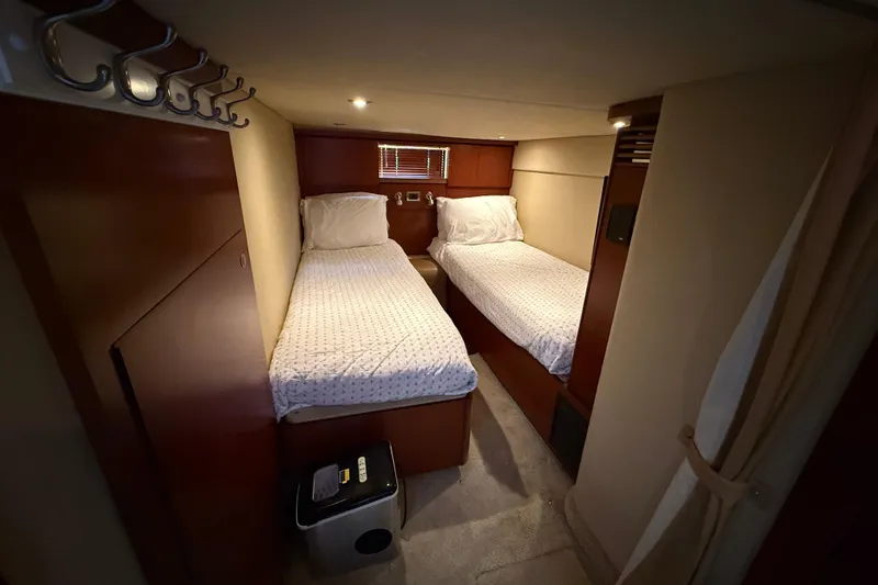 Turn The Page Yacht Photos Pics Interior cabin of 2006 Sea Ray 48 Sundancer with twin beds and wooden finish.