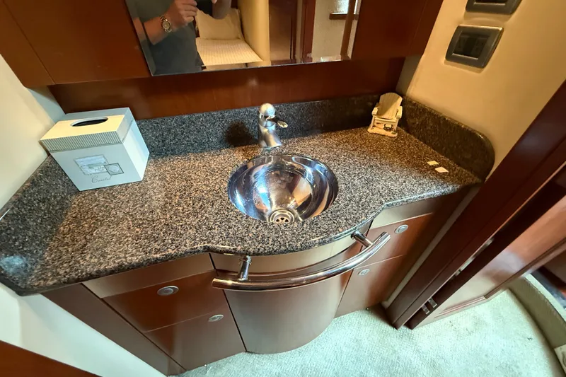 Turn The Page Yacht Photos Pics 2006 Sea Ray 48 Sundancer bathroom with granite countertop and stainless steel sink.