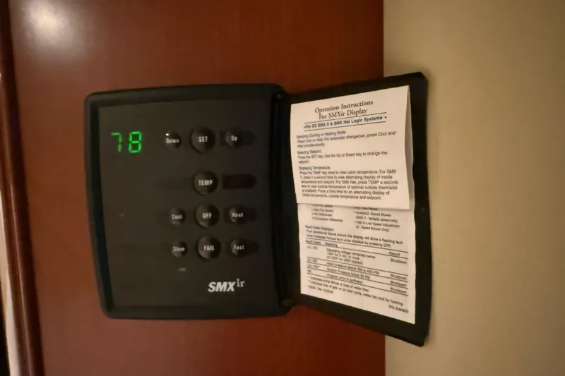 Turn The Page Yacht Photos Pics Thermostat control panel on a 2006 Sea Ray 48 Sundancer yacht, displaying temperature settings.