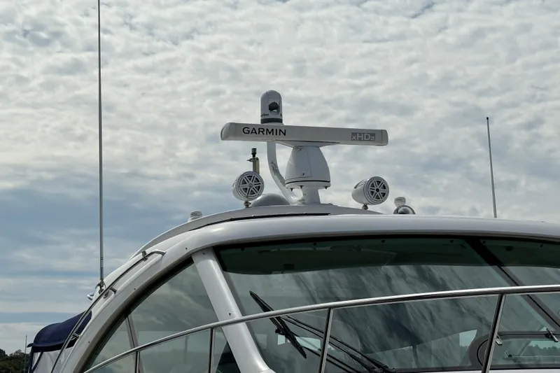 Turn The Page Yacht Photos Pics 2006 Sea Ray 48 Sundancer yacht with Garmin radar system under cloudy sky.