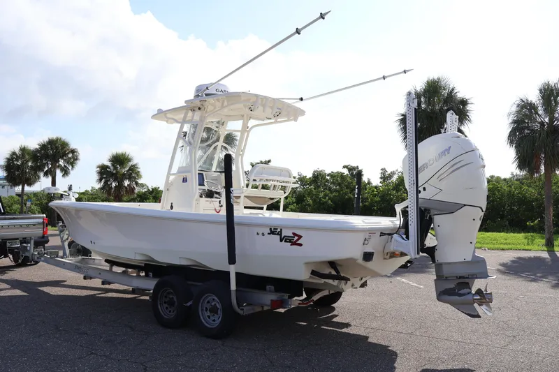  Yacht Photos Pics 2019 SeaVee 270Z boat on trailer with Mercury outboard, parked near palm trees.