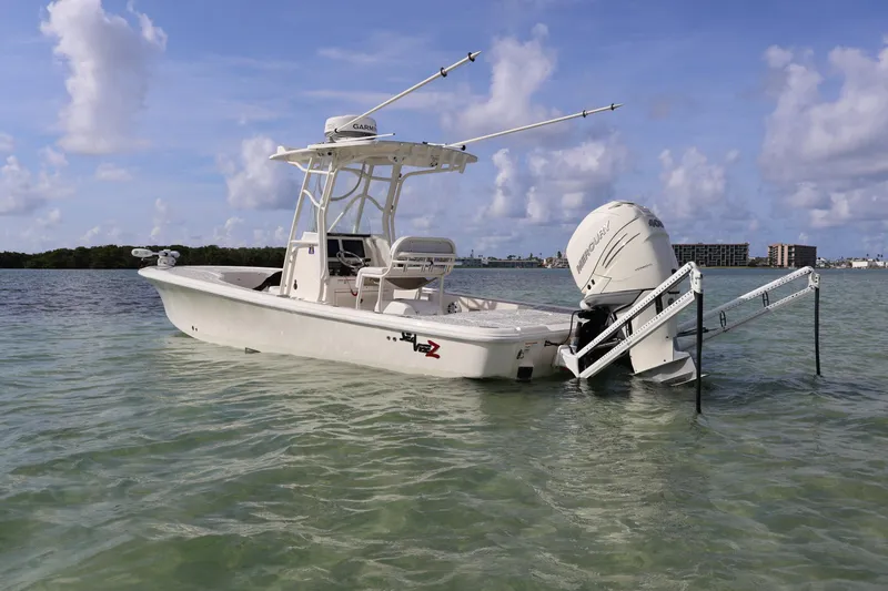  Yacht Photos Pics 2019 SeaVee 270Z boat in clear water, featuring a powerful outboard motor.