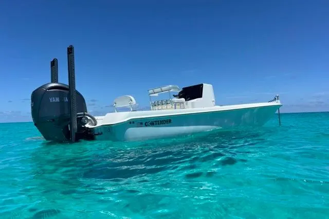  Yacht Photos Pics 2023 Contender 26 Bay boat on clear turquoise water under a bright blue sky.