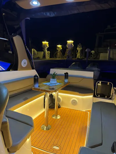  Yacht Photos Pics Luxurious 2024 Hanover 305 boat interior with ambient lighting and elegant seating.