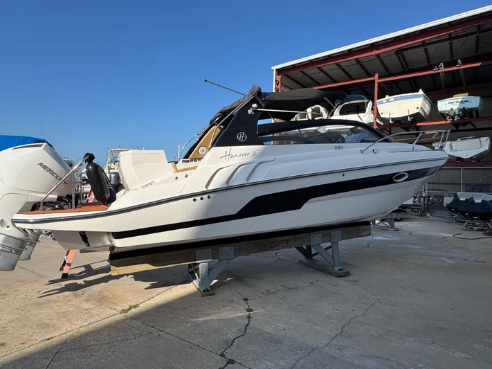  Yacht Photos Pics 2024 Hanover 305 boat on dry dock, white hull, outdoor storage area.