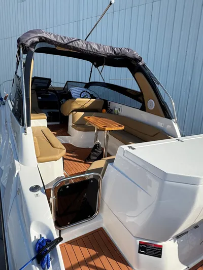  Yacht Photos Pics 2024 Hanover 305 boat with open deck, seating, and wooden table.