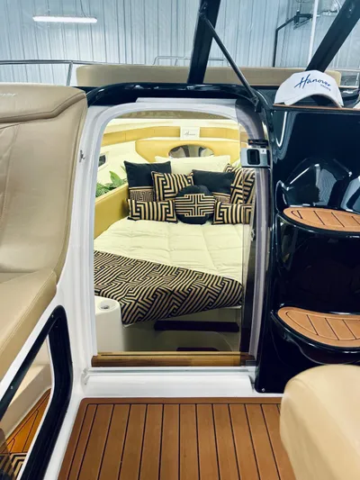  Yacht Photos Pics 2024 Hanover 305 yacht interior with luxurious seating and stylish geometric-patterned cushions.