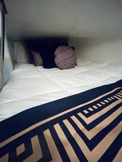  Yacht Photos Pics Cozy bed with geometric pillows in 2024 Hanover 305 interior.