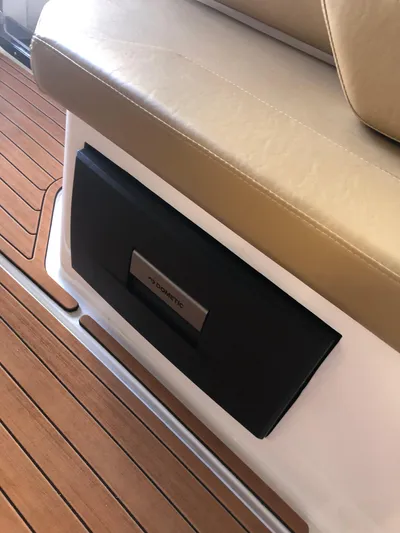  Yacht Photos Pics 2024 Hanover 305 boat interior with beige seating and wood flooring.