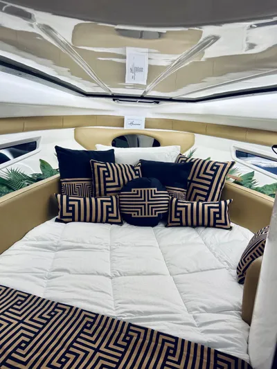  Yacht Photos Pics Luxurious interior of 2024 Hanover 305 boat with stylish geometric cushions and bedding.