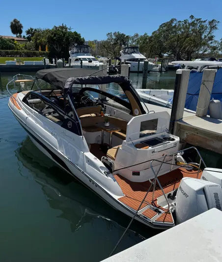  Yacht Photos Pics 2024 Hanover 305 boat docked in a marina under clear blue skies.