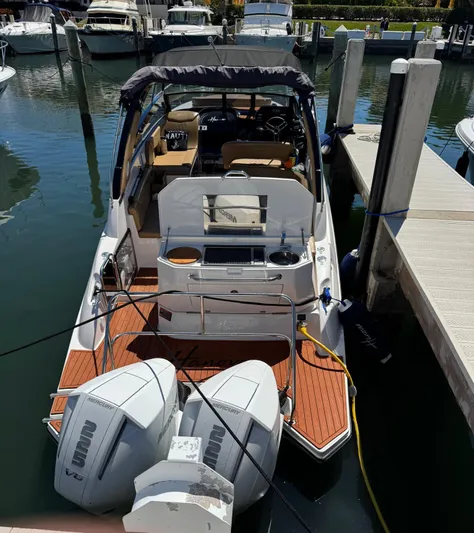  Yacht Photos Pics 2024 Hanover 305 boat docked, featuring dual outboard engines and a spacious deck area.