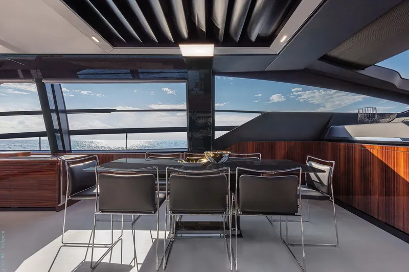  Yacht Photos Pics Luxurious interior of 2025 Riva Folgore yacht with ocean view and modern dining area.