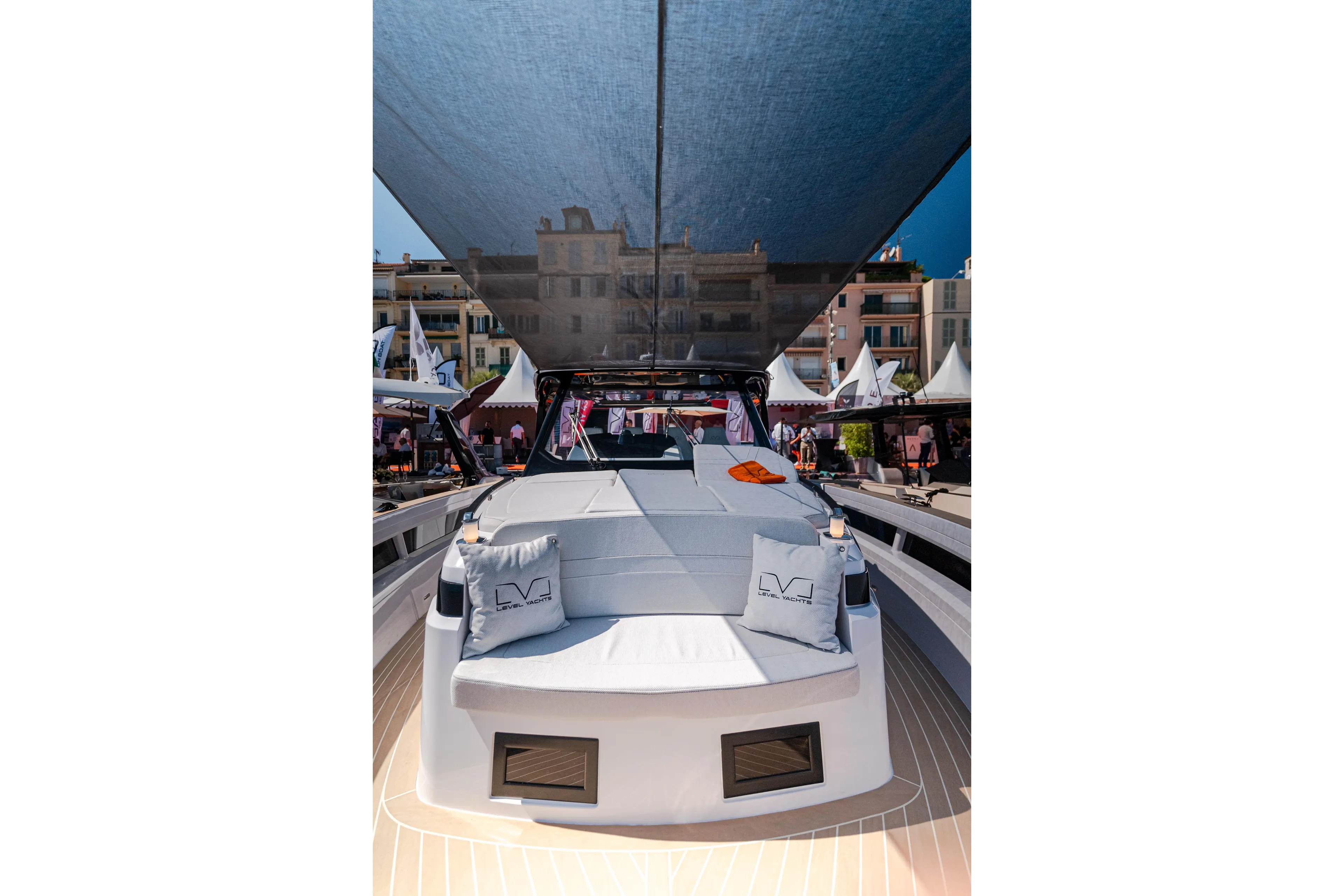 2026 Level Yachts 43 ST luxury yacht with sunshade and elegant seating at a marina.