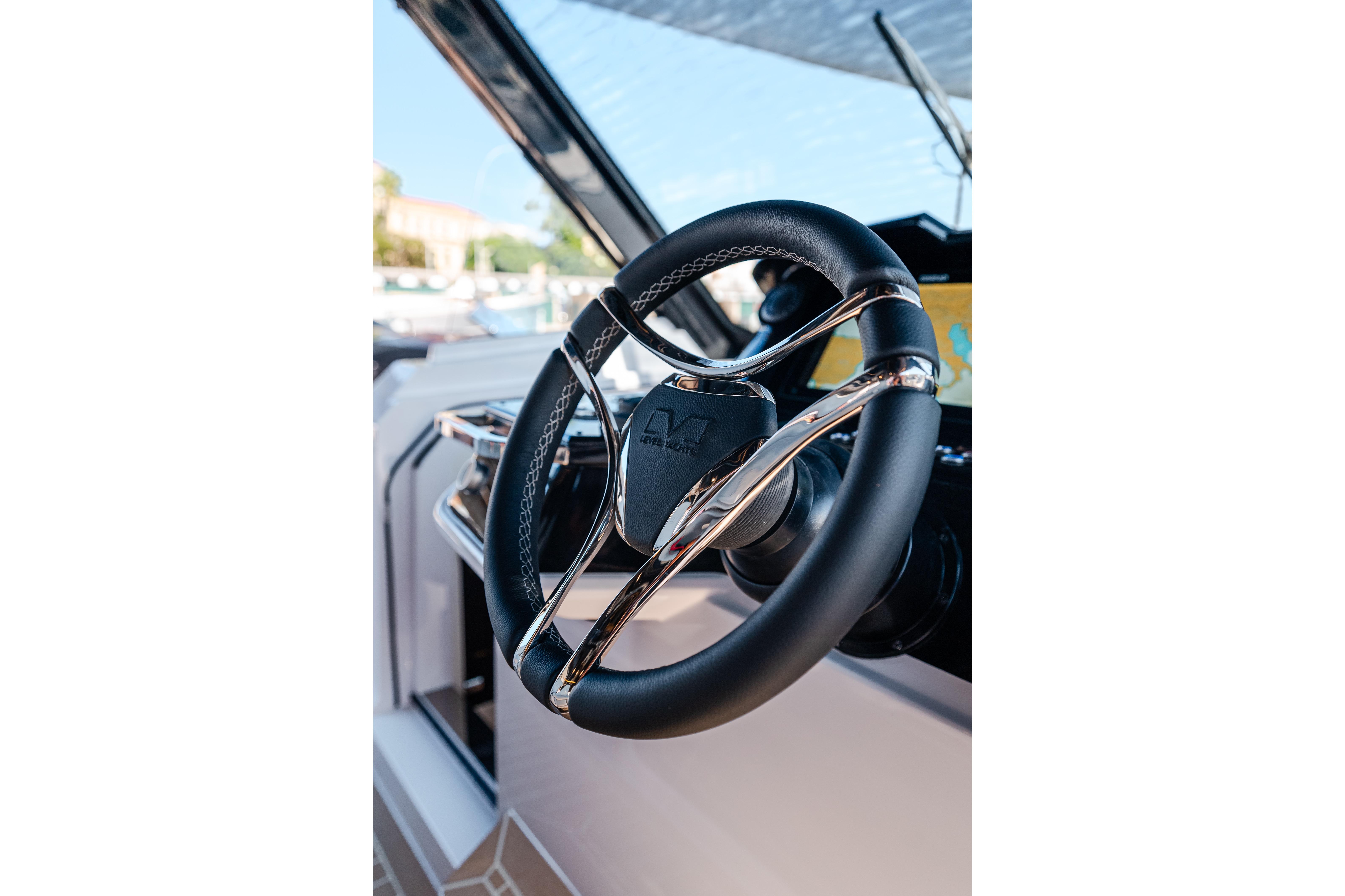 Steering wheel of 2026 Level Yachts 43 ST, featuring sleek design and modern controls.