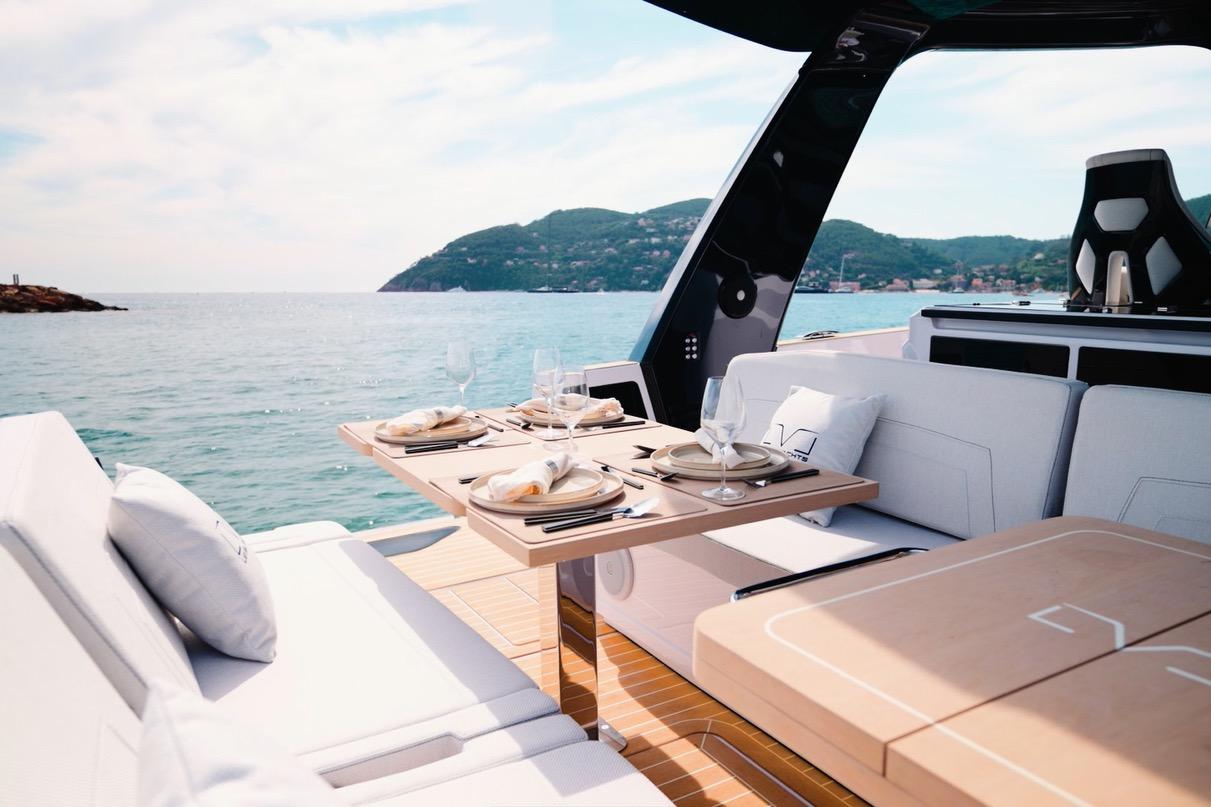 Luxurious 2026 Level Yachts 43 ST with elegant dining setup on deck, scenic ocean view.