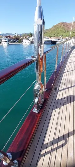  Yacht Photos Pics Luxurious Custom-Craft Steel Pax Navi yacht deck with polished railings, docked in a serene marina.