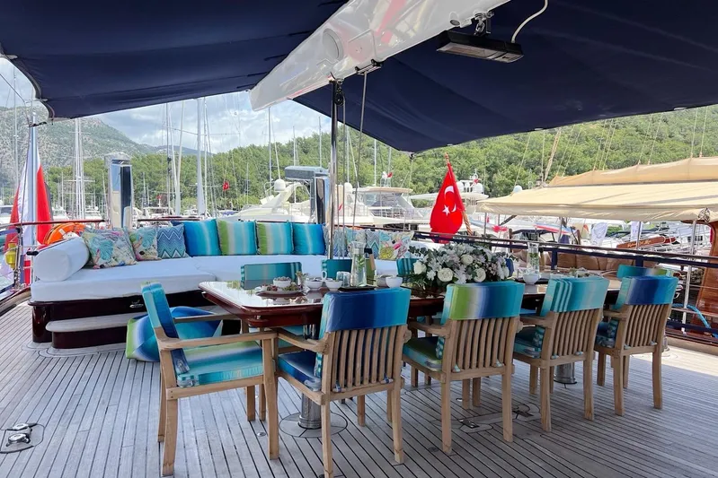  Yacht Photos Pics Luxurious yacht deck with dining area, colorful seating, and Turkish flag, Custom-Craft Steel Pax Navi 43 m.