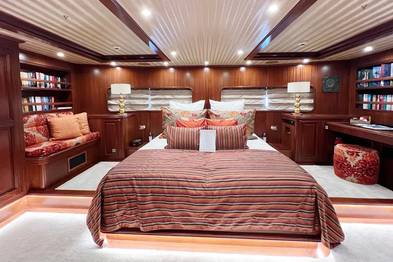  Yacht Photos Pics Luxurious yacht bedroom with striped bedding, wooden decor, and ambient lighting on Custom-Craft Steel Pax Navi 43 m.