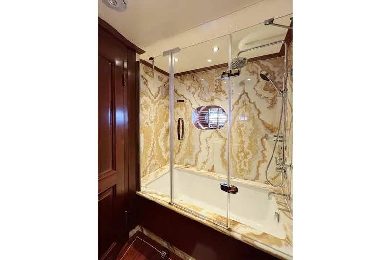  Yacht Photos Pics Luxurious yacht bathroom with marble walls, glass shower, and wooden accents, Custom-Craft Steel Pax Navi 43 m.