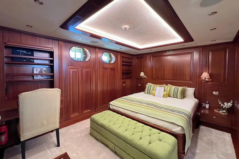  Yacht Photos Pics Luxurious bedroom interior on 2010 Custom-Craft Steel Pax Navi yacht, featuring elegant wood paneling.