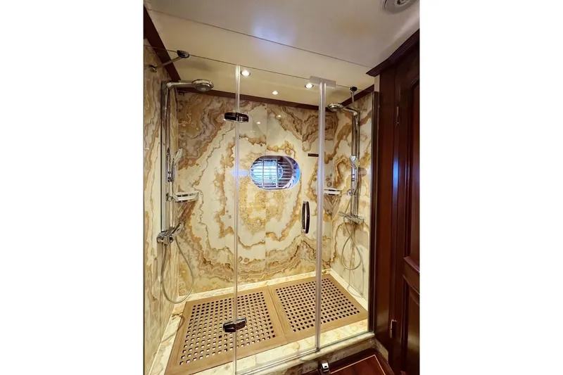  Yacht Photos Pics Luxurious marble shower in 2010 Custom-Craft Steel Pax Navi yacht, featuring dual showerheads.