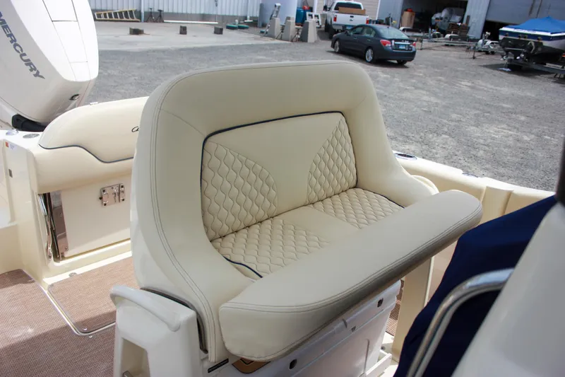  Yacht Photos Pics 2024 Chris-Craft Catalina 24 boat seat with quilted upholstery in a marina setting.
