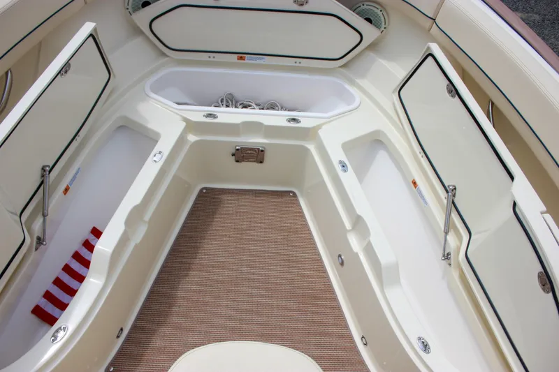 Yacht Photos Pics 2024 Chris-Craft Catalina 24 boat interior with storage compartments and beige flooring.