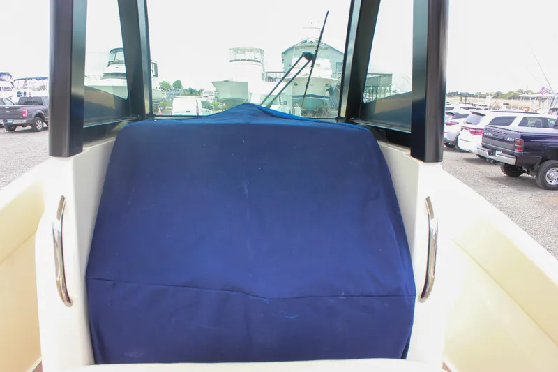  Yacht Photos Pics 2024 Chris-Craft Catalina 24 boat with blue cover, parked in a marina.