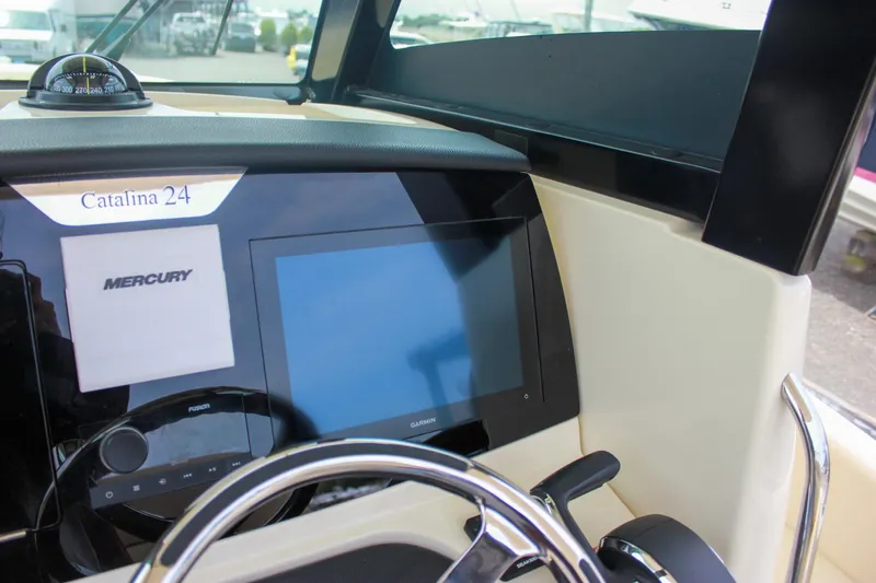  Yacht Photos Pics 2024 Chris-Craft Catalina 24 dashboard with Mercury display and steering wheel.