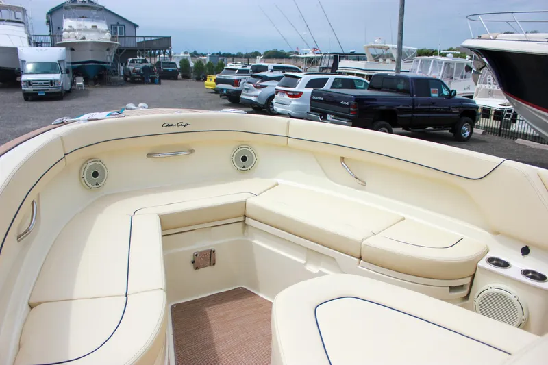  Yacht Photos Pics 2024 Chris-Craft Catalina 24 boat interior with beige seating, parked in a marina.