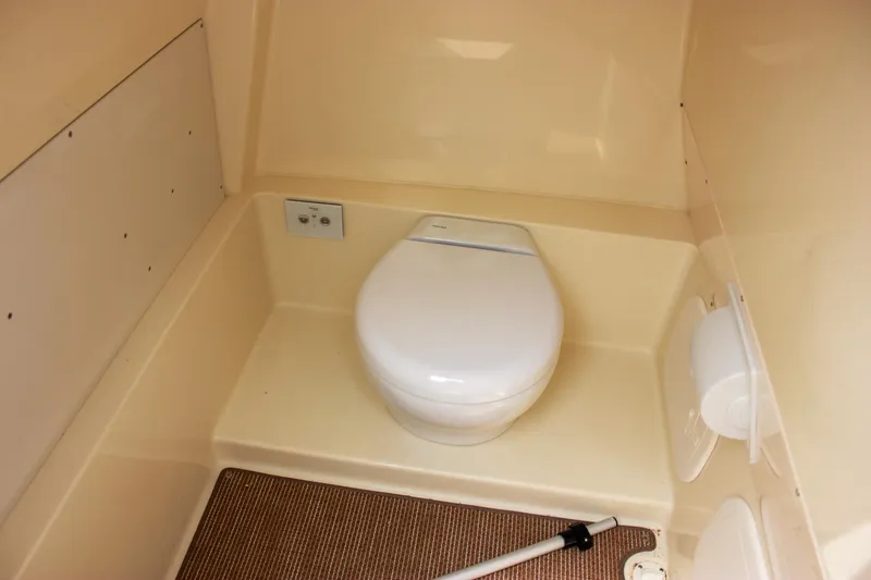  Yacht Photos Pics 2024 Chris-Craft Catalina 24 boat interior with compact marine toilet.