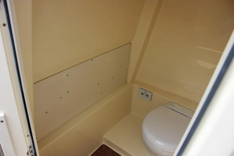  Yacht Photos Pics 2024 Chris-Craft Catalina 24 boat interior with compact marine toilet.