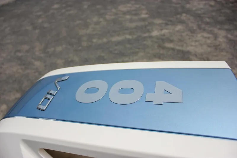  Yacht Photos Pics 2024 Chris-Craft Catalina 24 boat engine cover with blue and white design.