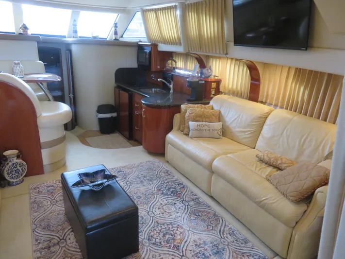  Yacht Photos Pics Luxurious interior of 2004 Carver 420 Mariner yacht with leather sofa and kitchenette.