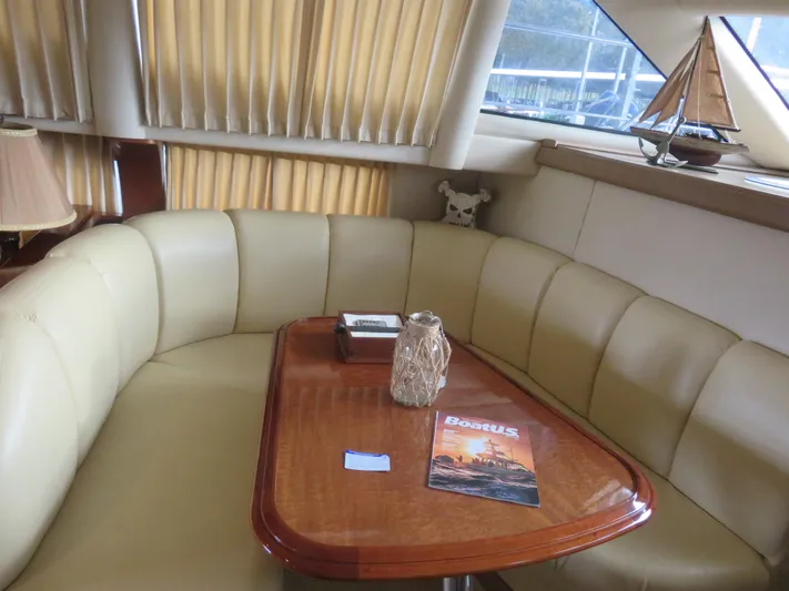  Yacht Photos Pics Luxurious interior of 2004 Carver 420 Mariner yacht with plush seating and wooden table.