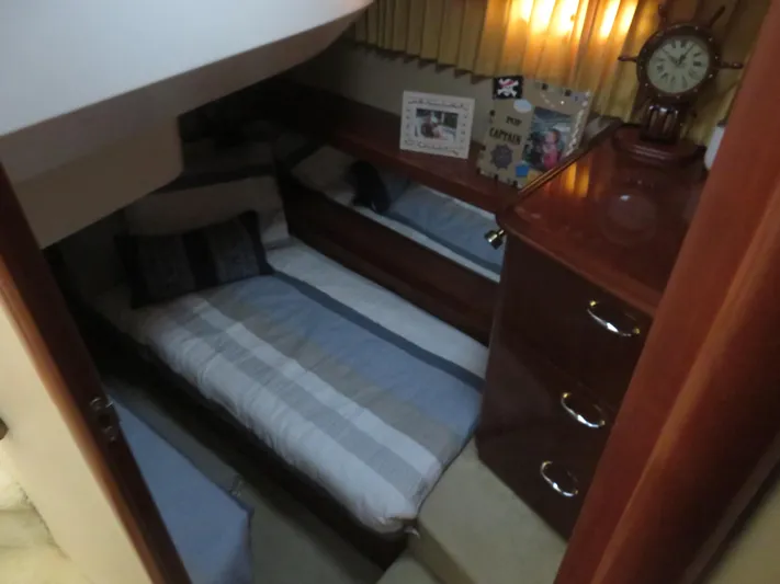  Yacht Photos Pics Cozy cabin interior of 2004 Carver 420 Mariner with bed and wooden furnishings.