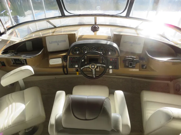  Yacht Photos Pics Interior helm of 2004 Carver 420 Mariner yacht with leather seating and navigation controls.