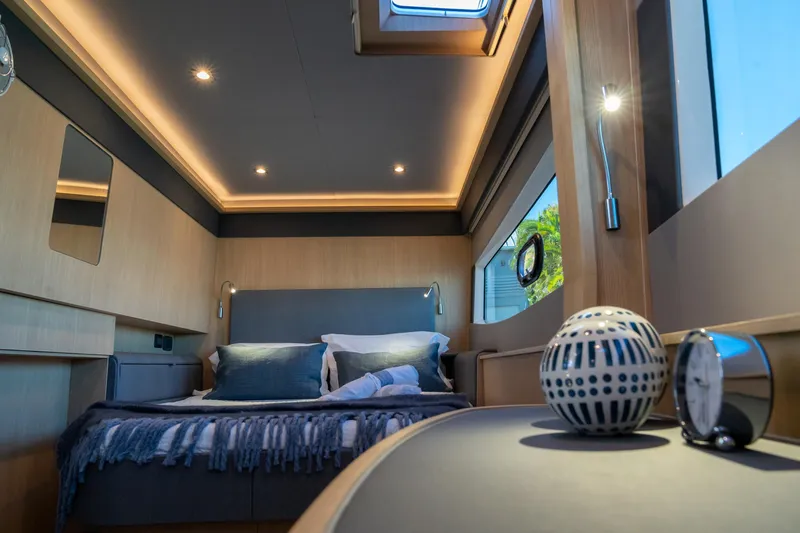 Superlux Yacht Photos Pics Luxurious interior of 2023 Aquila 42 Yacht bedroom with modern decor and ambient lighting.