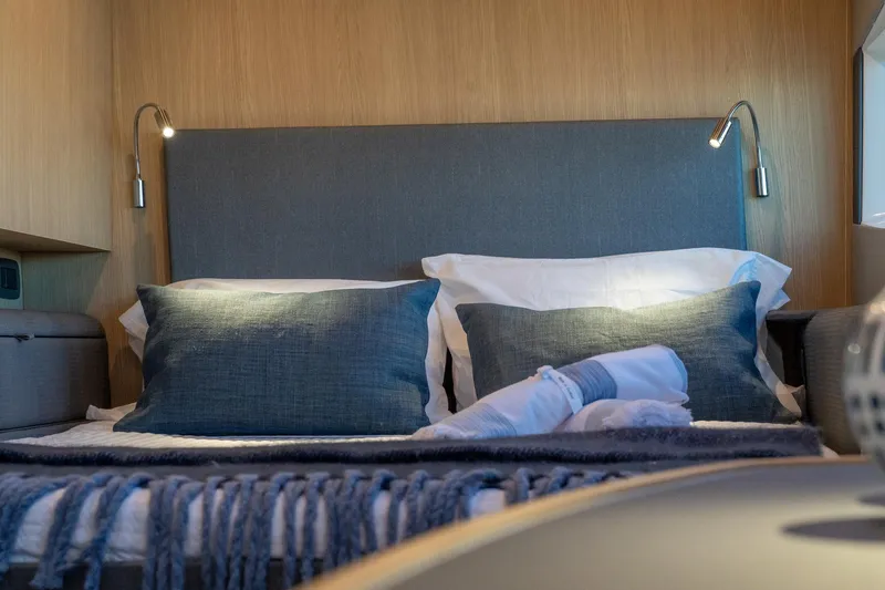 Superlux Yacht Photos Pics Luxurious bedroom interior of 2023 Aquila 42 Yacht with elegant bedding and ambient lighting.