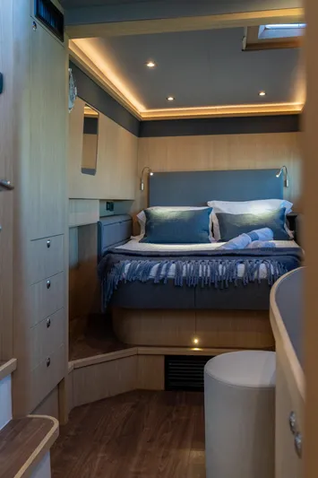 Superlux Yacht Photos Pics Luxurious bedroom interior of 2023 Aquila 42 Yacht with modern lighting and cozy bedding.